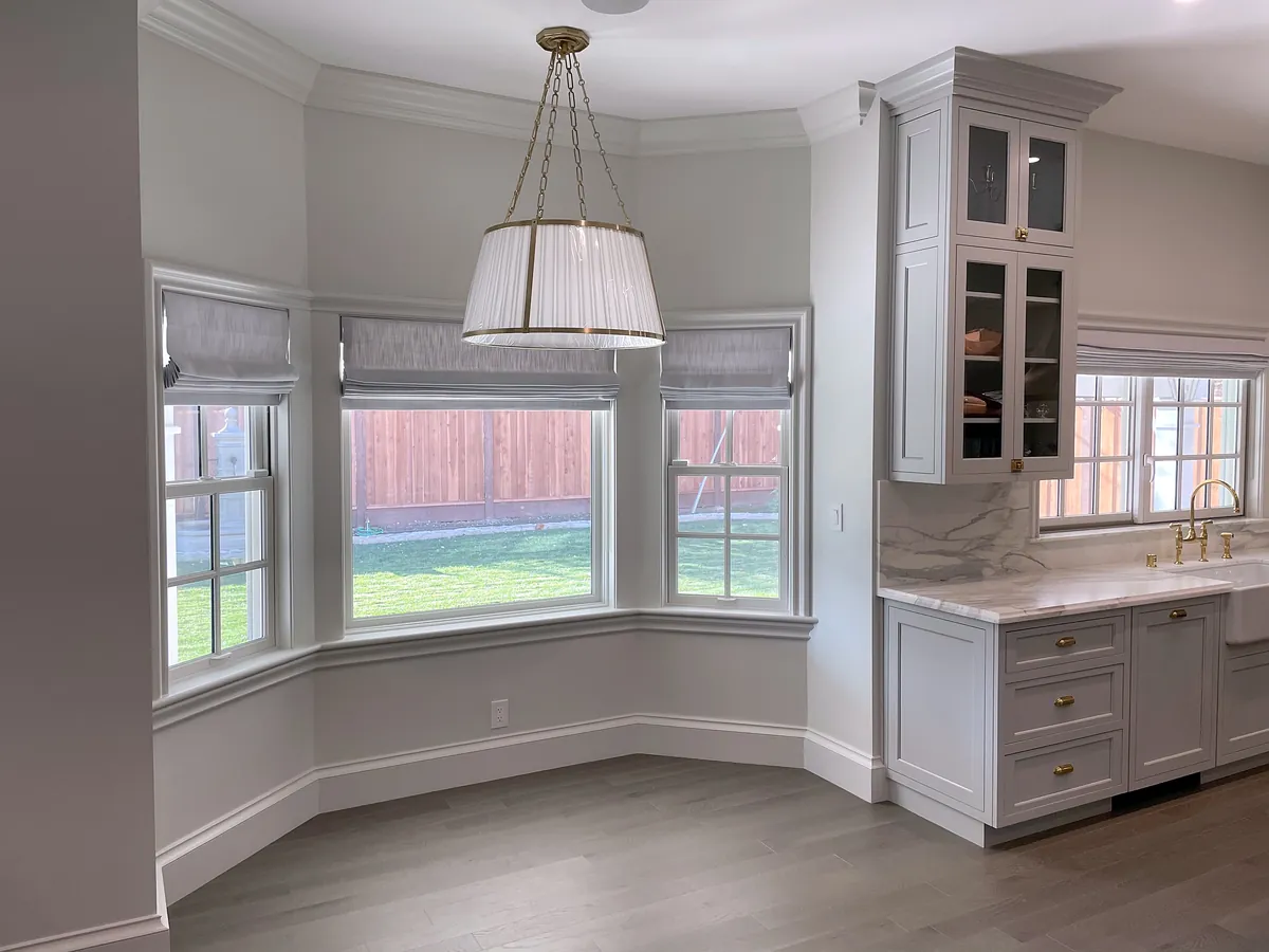 Bay-window breakfast nook with a drum pendant