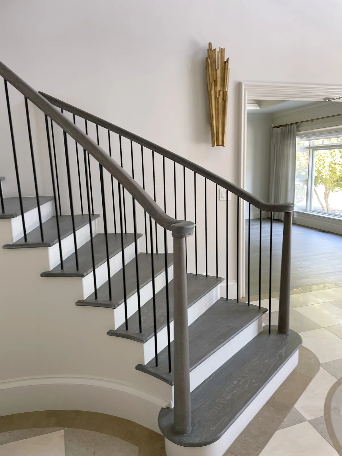 Staircase with dark treads and iron balusters