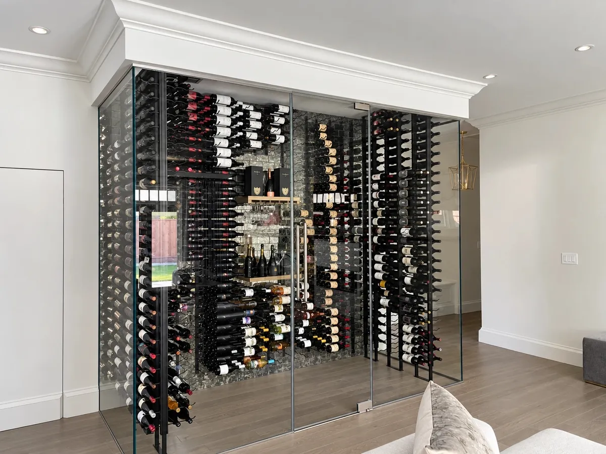 Glass-enclosed wine room with floor-to-ceiling racks