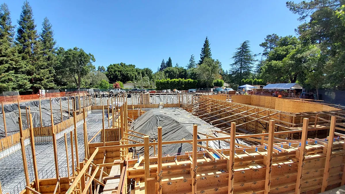 Wide view of a new home's foundation: formwork, rebar mats and protected excavation